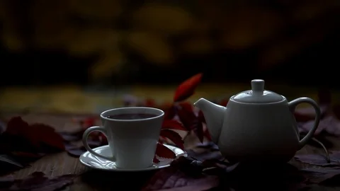 On the table is hot tea and teapot steam comes from a cup. Stock Footage 120427516