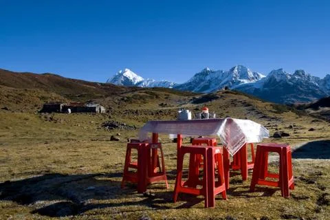Table laid for breakfast with a view of the high  mountains Stock Photos