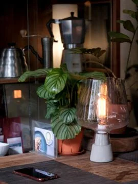 Table lamp with coffee maker as background Stock Photos