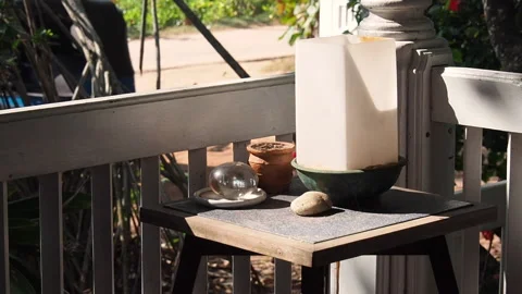 A table with a lamp in the corner of the veranda, on a lazy, warm summer day Stock Footage 153044412