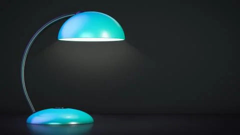 The table lamp is on. Dark background. Copy space. Stock Photos