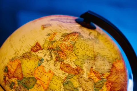 A table lamp in the form of a globe, a rotating globe of the earth on a blue Stock Photos
