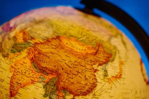A table lamp in the form of a globe, a rotating globe of the earth on a blue 스톡 사진
