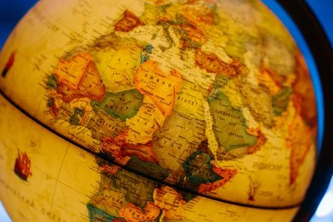 A table lamp in the form of a globe, a rotating globe of the earth on a blue Stock Photos