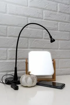 Table lamp. Mirror. Decorative wall Stock Photos
