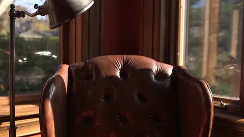Table lamp next to arm chair in living room at home Stock Footage 83860486