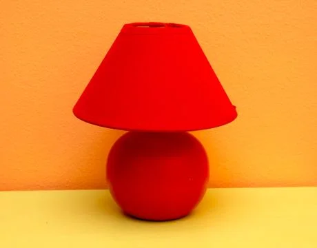 Table lamp on a red table yellow Stock Photos
