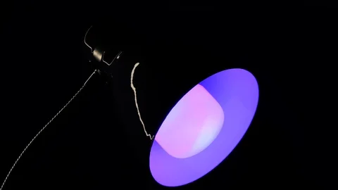 Table lamp studio video LED light changing color filters red, blue, green, orang Stock Footage 130055543