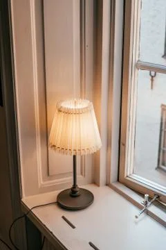 Table lamp by the window Stock Photos