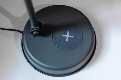 Table lamp with a wireless charging pad Stock Photos