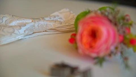 On the table lay a beautiful boutonniere and cufflinks 스톡 동영상 69748631
