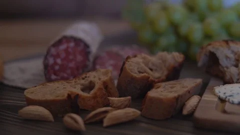 On the table lay the slices of the sausage and the loaf of servilda. In the Stock Footage 81955432