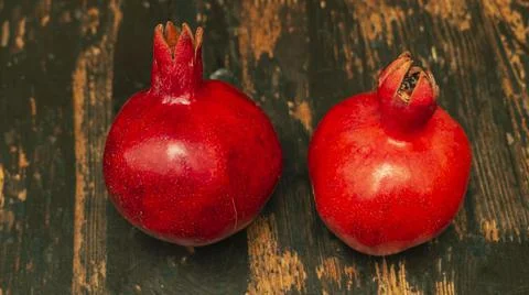 On the table lay two red pomegranate. Two ripe garnet on the wooden table. Ha Foto stock