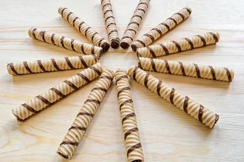 On the table lie waffle tubes in the shape of the sun Stock Photos