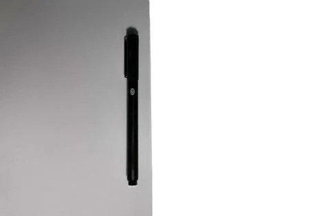 On a table lies a clean notebook for drawing and a black gel pen on it. Stock Photos