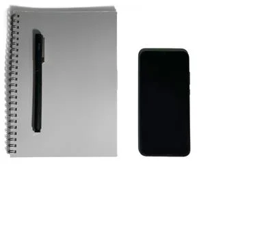 On a table lies a notebook with pen on it. There is a black phone next to it. Stock Photos