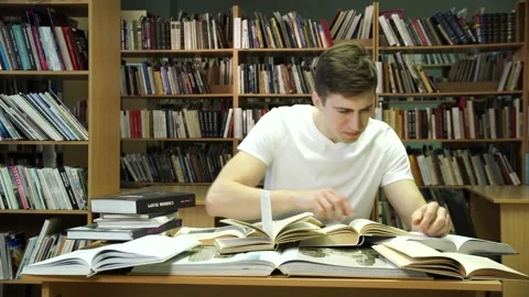 The table is littered with books 스톡 동영상 155962898