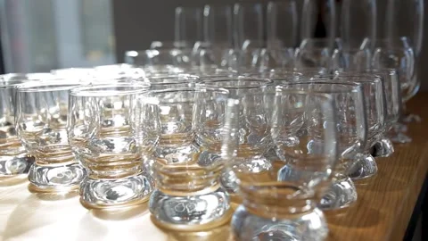 A table made of glasses and cups of different sizes for different drinks. Stock Footage 164870939