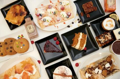 A table with many different types of desserts and pastries Stock Photos