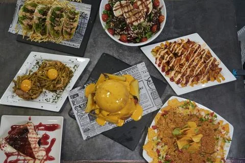 A table with many different types of food, including a sandwich with cheese Stock Photos
