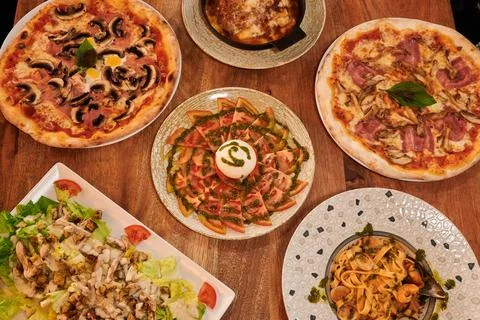 A table with many different types of food, including nachos, tacos Stock-Fotos