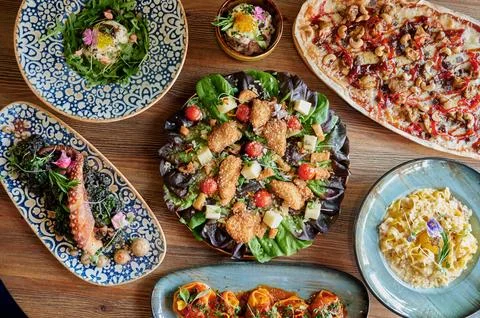 A table with many different types of food on it Stock Photos