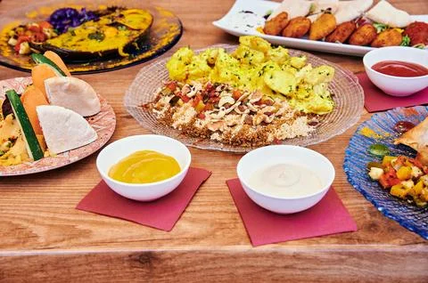 A table with many different types of food on it Stock Photos
