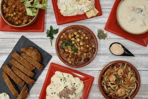 A table with many different types of food on it Stock Photos