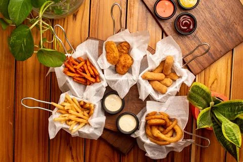 A table with many fried snacks and sauces Stock Photos