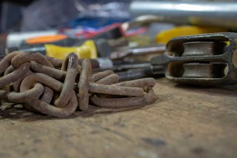 Table of a mechanical and electrician workshop, with an old chain and another Stock-Fotos