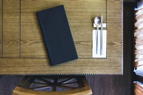 Table with a menu and silverware Stock Photos