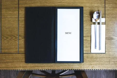 Table with a menu and silverware Stock-Fotos