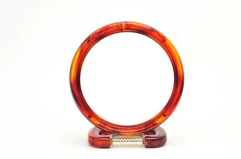 Table mirror in amber frame on a white background Stock Photos