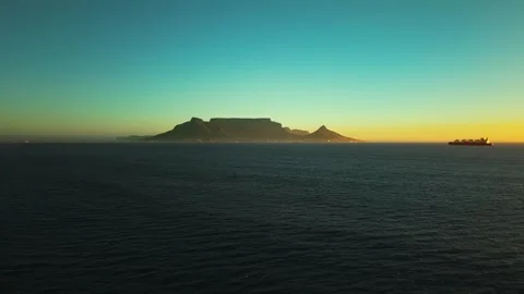 Table Mountain and a cargo ship at sunset, cinematic aerial Stock Footage 342743213