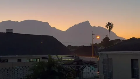 Table Mountain and Devils Peak Cape Town at Dusk as seen from Cape Flats. Video stock 337935063