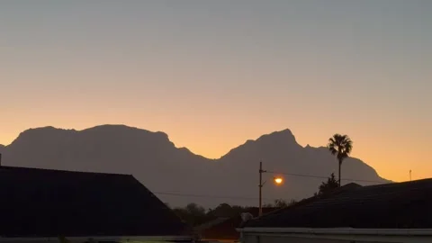 Table Mountain at dusk as seen from the Cape Flats. Stock Footage 337935050