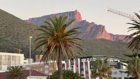 Table Mountain lit up during Sunset on a clear day in Sea Point, Cape Town Video stock 337652635