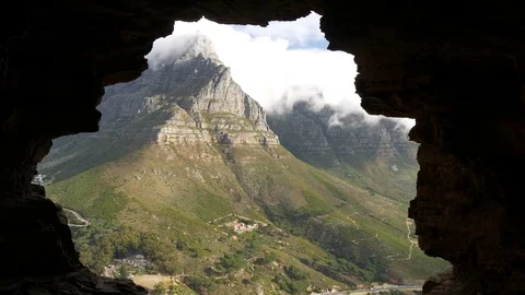 Table Mountain peak viewed from and framed by a cave outline, Cape Town Stock Footage 83501917