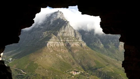 Table Mountain peak viewed from and framed by a cave, Cape Town Stock Footage 83501961