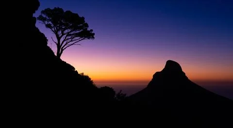 Table Mountain Silhouette sunset after dusk with a beautiful view of Lion's Head Stock Photos