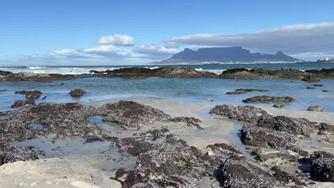 Table Mountain views from a rocky beach of Table Bay Stock Footage 249325938
