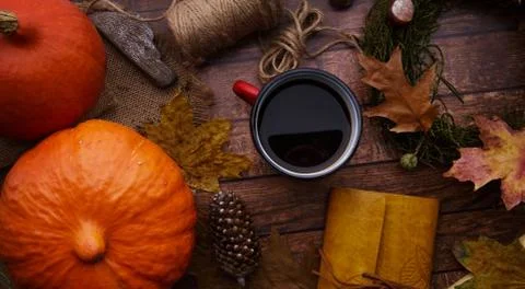 On the table a mug of coffee pumpkin and decoration Stock Photos