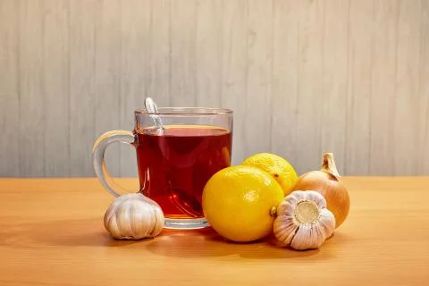On the table mug with tea lemons garlic onions Stock Photos
