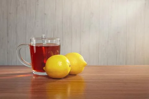 On the table a mug of tea with lemons Stock Photos