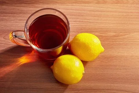 On the table a mug of tea with lemons top view Stock Photos