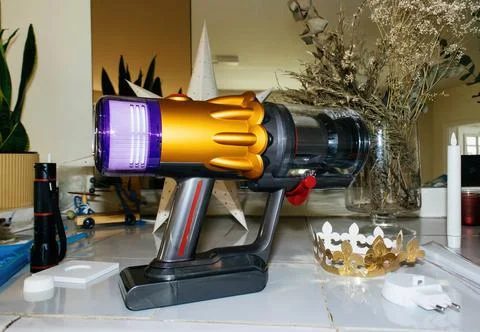 Table with multiple objects main hero object new cordless vacuum cleaner with Stock Photos