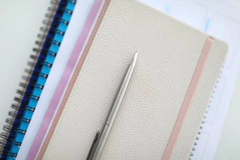 On table is notebook and silver pen closeup Stock Photos