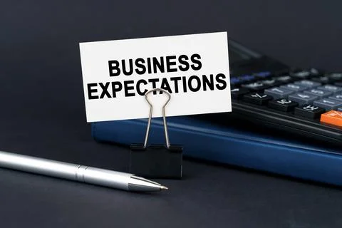 On the table is a notebook, a calculator, a pen and a business card with th.. Stock Photos