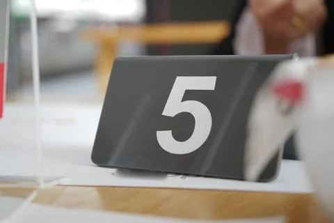 Table number five in a busy restaurant setting Stock Photos