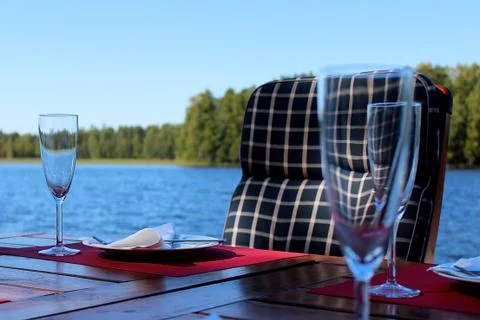 Table outside by the water. Stock Photos